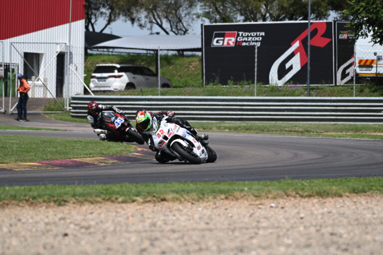 A camera shy rider behind Jason Lamb through turn 4 and Johan LeRoux in the background