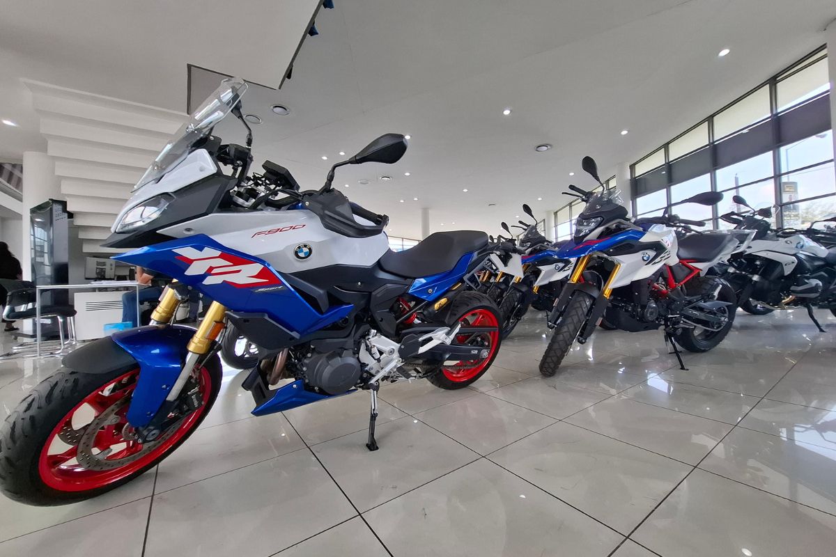 BMW Motorrad GS adventure bike in South Africa BMW R 1300 GS Adventure touring motorcycle BMW F 900 GS Adventure on a dirt road BMW Motorrad dealership showroom in South Africa Riding gear and helmet display at BMW Motorrad store