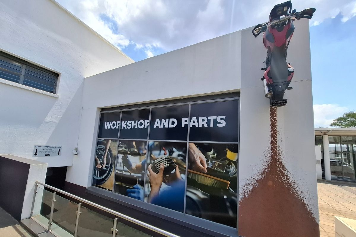 BMW Motorrad GS adventure bike in South Africa BMW R 1300 GS Adventure touring motorcycle BMW F 900 GS Adventure on a dirt road BMW Motorrad dealership showroom in South Africa Riding gear and helmet display at BMW Motorrad store