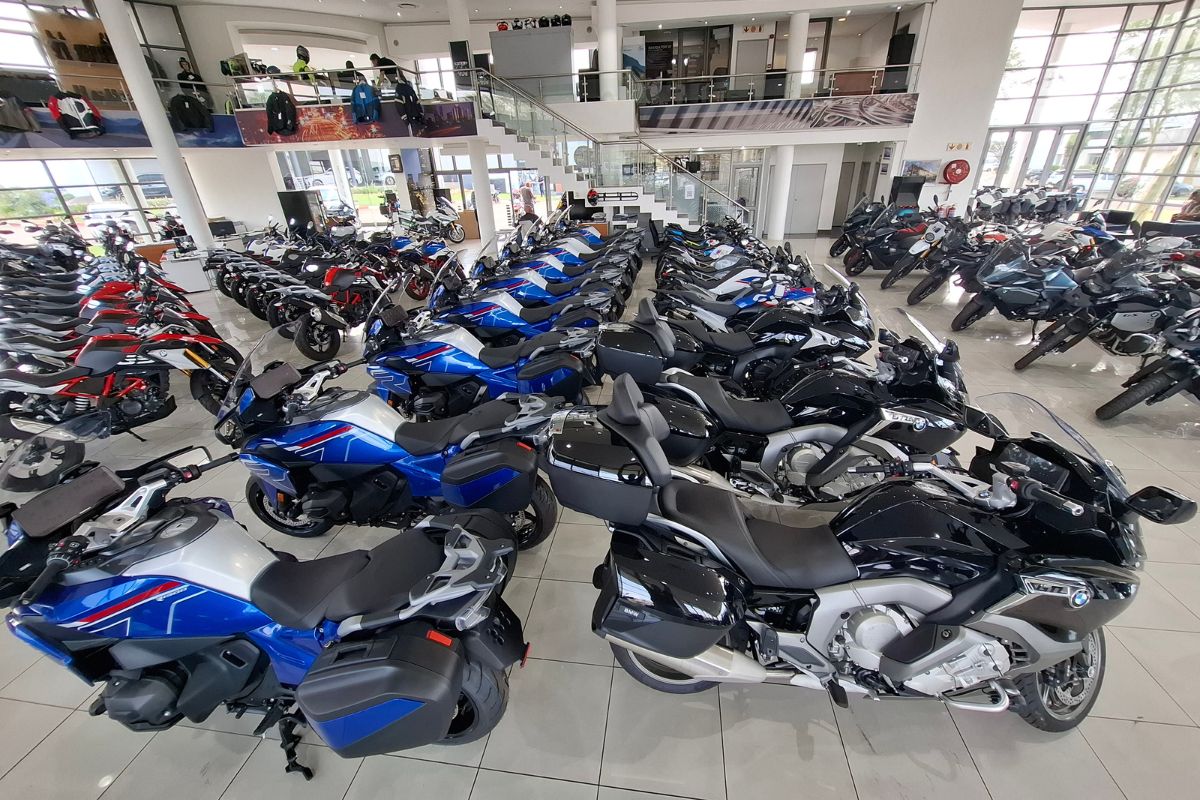 BMW Motorrad GS adventure bike in South Africa BMW R 1300 GS Adventure touring motorcycle BMW F 900 GS Adventure on a dirt road BMW Motorrad dealership showroom in South Africa Riding gear and helmet display at BMW Motorrad store