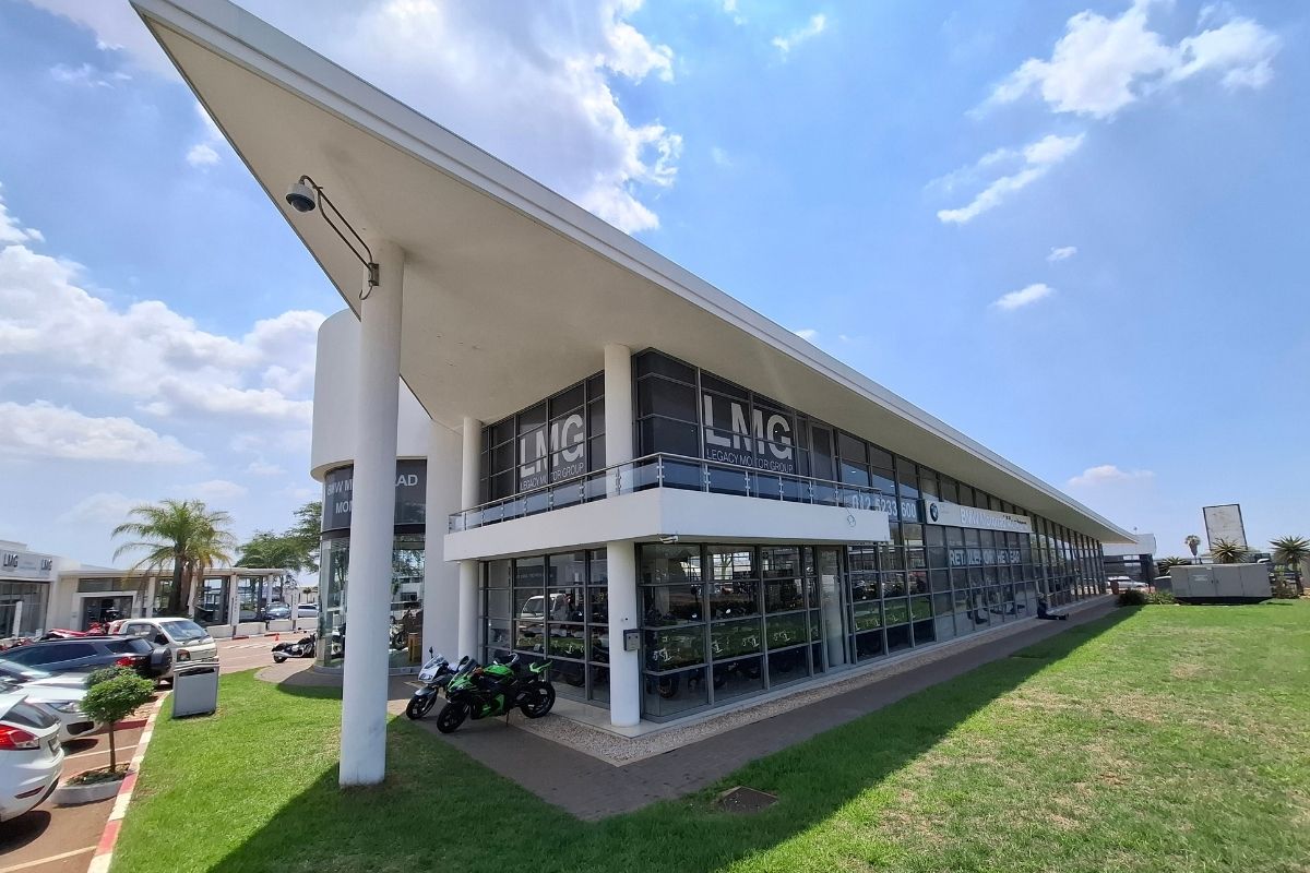 BMW Motorrad GS adventure bike in South Africa BMW R 1300 GS Adventure touring motorcycle BMW F 900 GS Adventure on a dirt road BMW Motorrad dealership showroom in South Africa Riding gear and helmet display at BMW Motorrad store