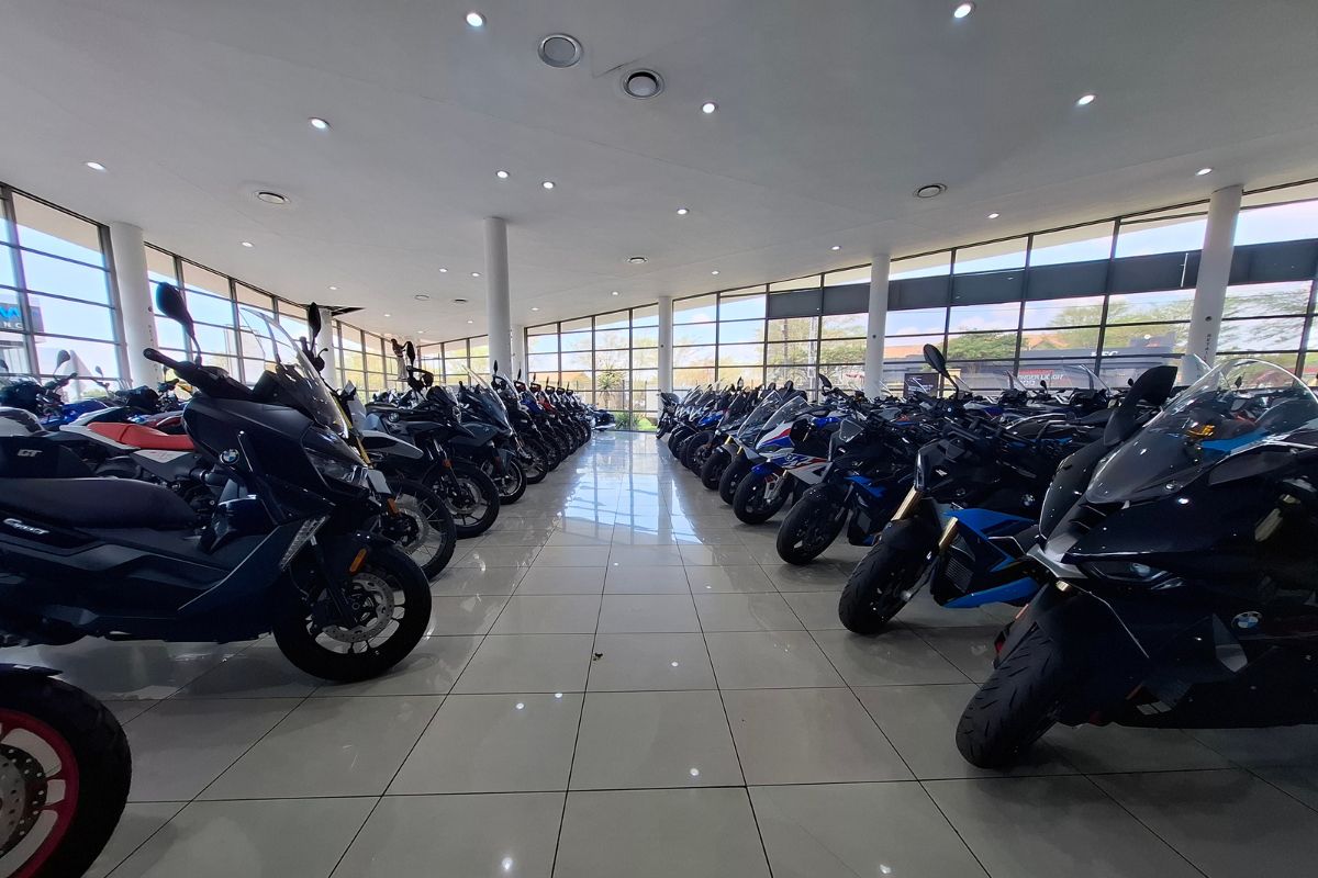 BMW Motorrad GS adventure bike in South Africa BMW R 1300 GS Adventure touring motorcycle BMW F 900 GS Adventure on a dirt road BMW Motorrad dealership showroom in South Africa Riding gear and helmet display at BMW Motorrad store