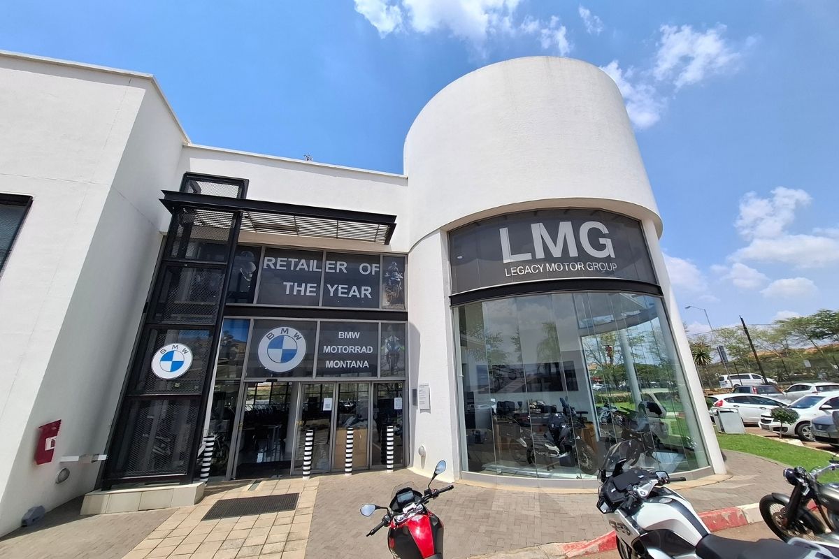 BMW Motorrad GS adventure bike in South Africa BMW R 1300 GS Adventure touring motorcycle BMW F 900 GS Adventure on a dirt road BMW Motorrad dealership showroom in South Africa Riding gear and helmet display at BMW Motorrad store